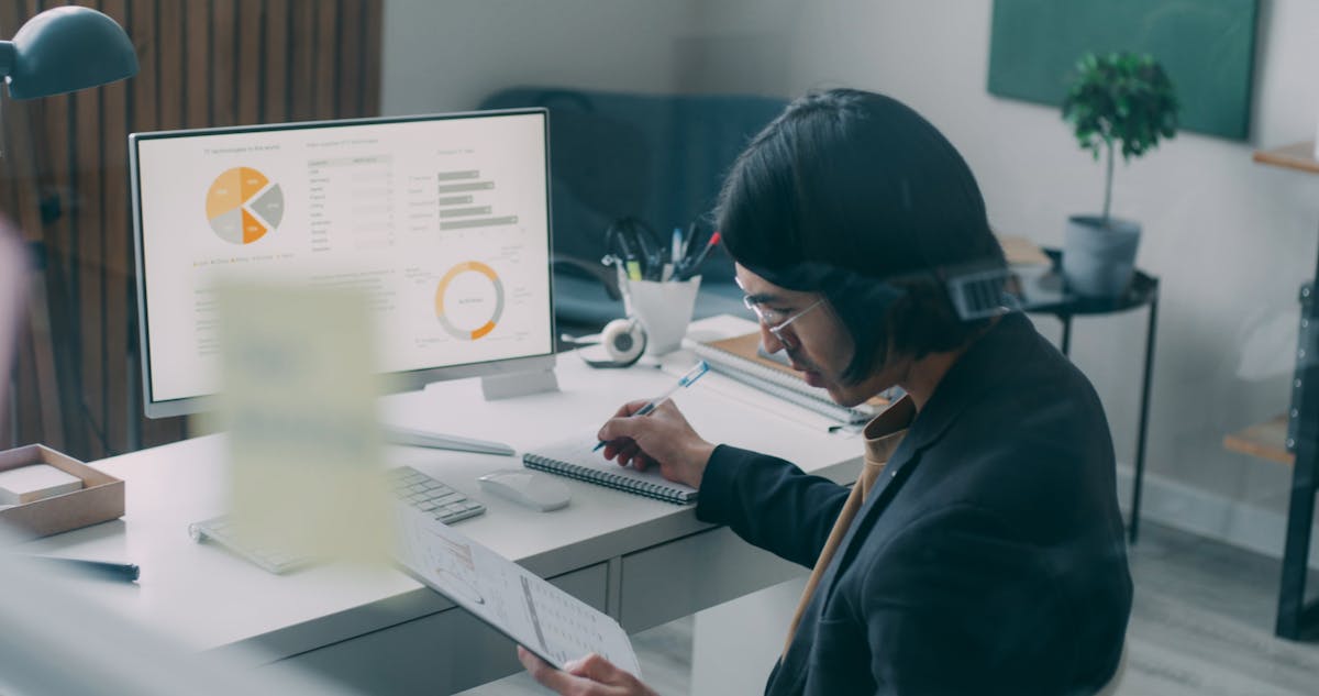 Professional reviewing charts and reports at a desk