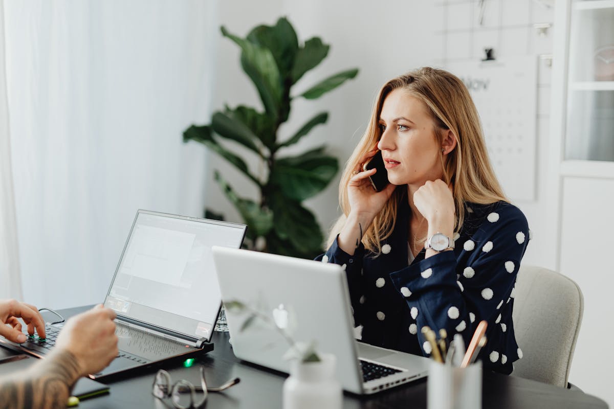 Laptop and phone used for insurance workflow coordination