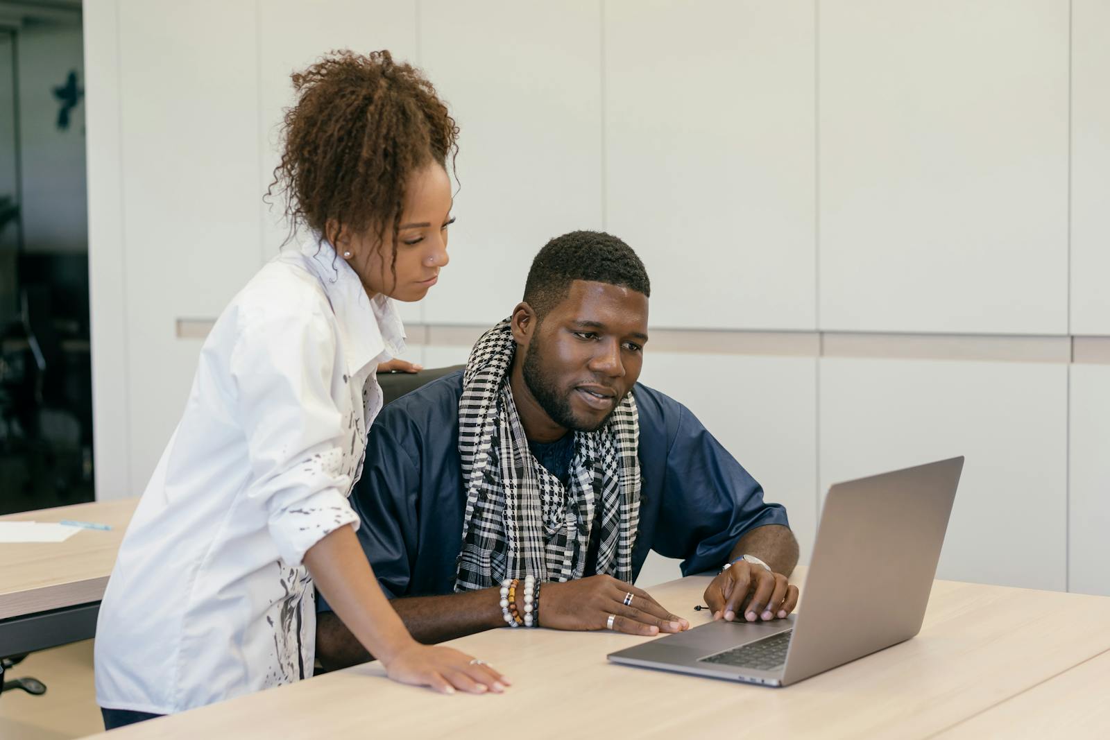 Two professionals reviewing a laptop during a scoped service planning session