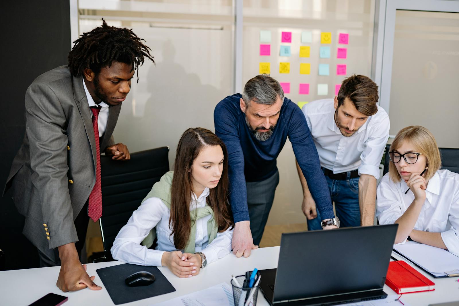 Business team reviewing a laptop during a service planning session